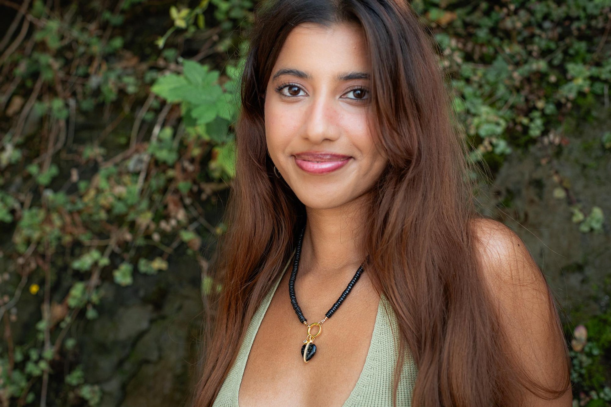 Black spinel and topaz heart pendant necklace by Earthly Abundance with a delicate chain and sparkling gemstones.