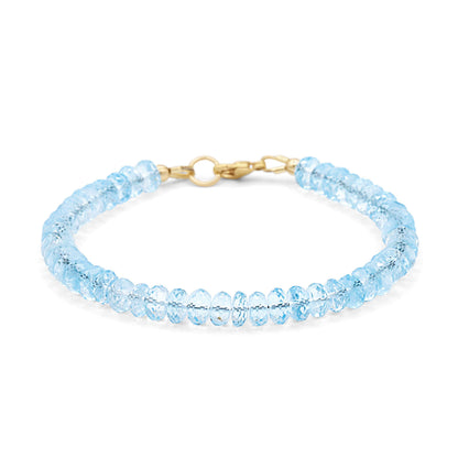 Swiss Blue Topaz bracelet in 14K gold with sparkling blue gemstones, featuring a delicate and elegant design.