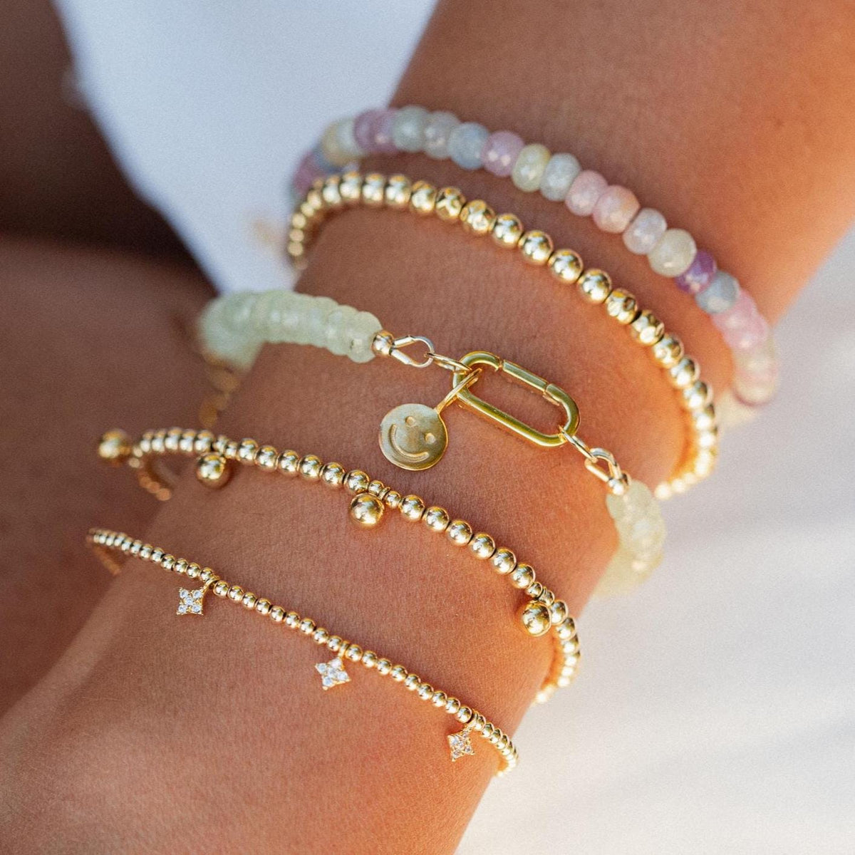 Prehnite beaded bracelet with carabiner clasp by Earthly Abundance, featuring smooth green stones on an elastic cord.