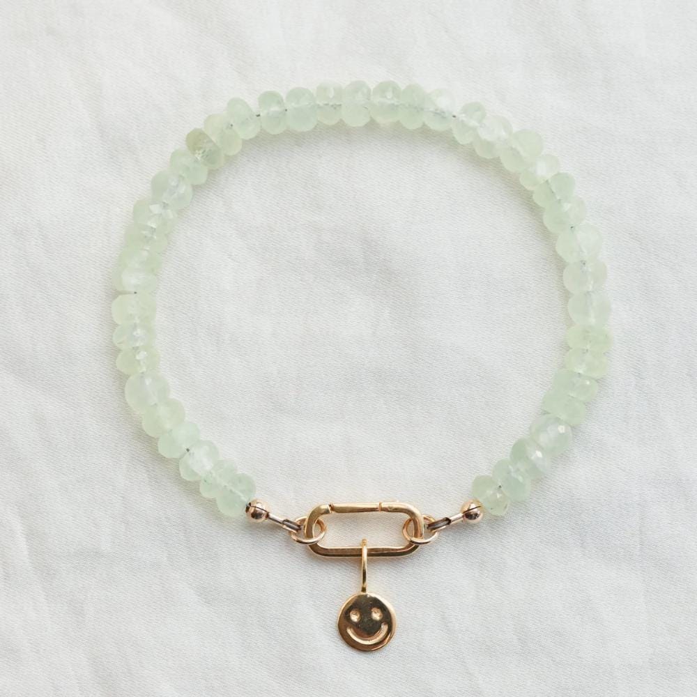 Prehnite beaded bracelet with carabiner clasp from Earthly Abundance, featuring smooth green gemstones on a natural jewelry piece.