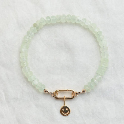 Prehnite beaded bracelet with carabiner clasp from Earthly Abundance, featuring smooth green gemstones on a natural jewelry piece.