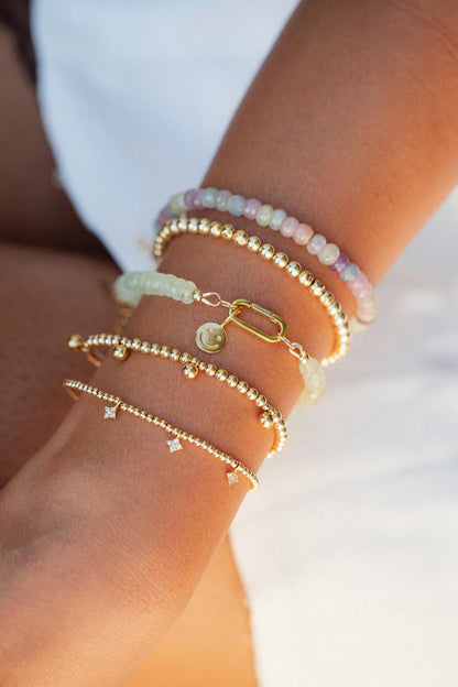 Prehnite beaded bracelet with silver carabiner clasp by Earthly Abundance, featuring smooth round green gemstone beads.