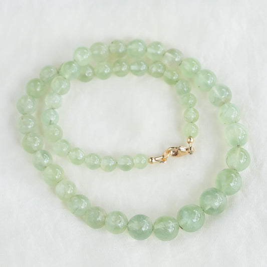 Prehnite glow necklace featuring a polished green prehnite pendant on a delicate chain, designed by Earthly Abundance.