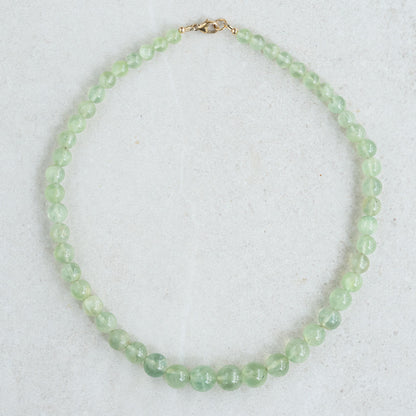 Prehnite glow necklace by Earthly Abundance featuring a smooth green gemstone pendant on a silver chain.