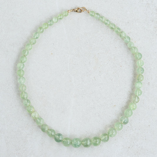 Prehnite glow necklace by Earthly Abundance featuring a smooth green gemstone pendant on a silver chain.