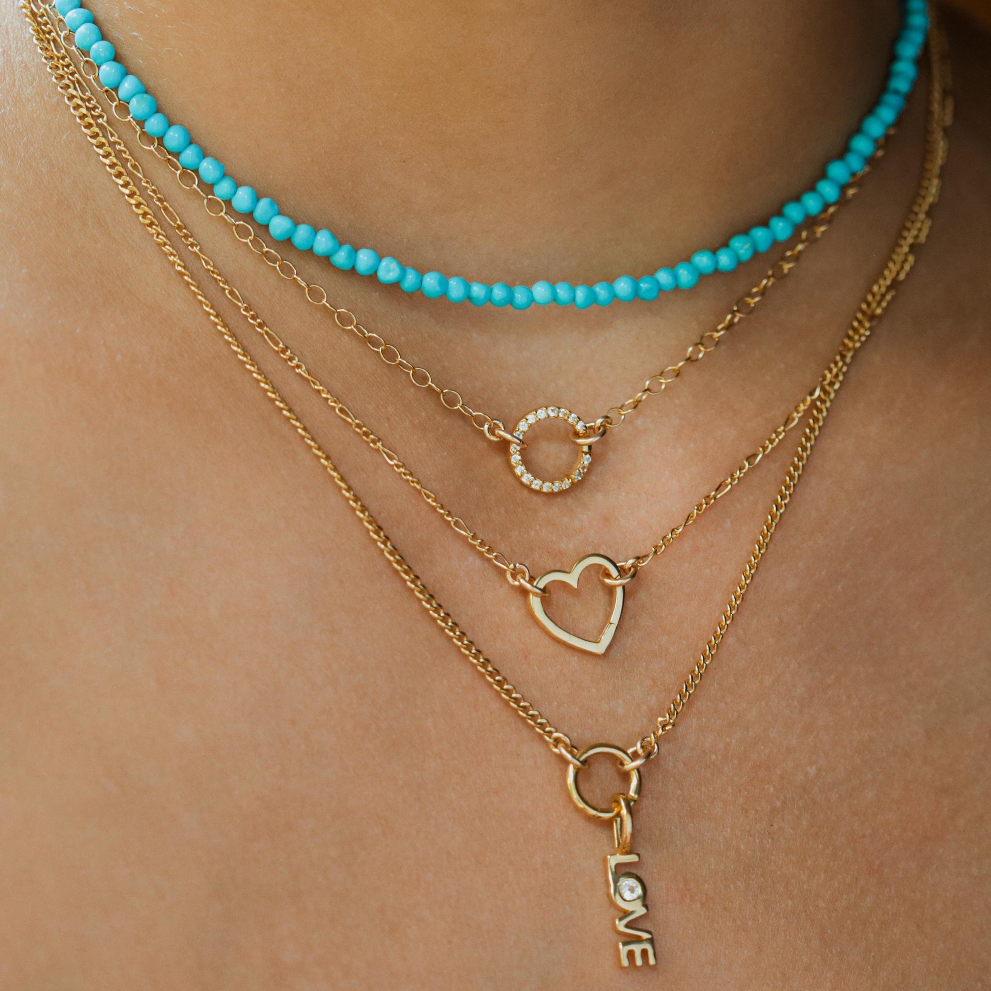 14k gold-filled Figaro chain necklace by Earthly Abundance, showcasing its layered, polished links on a neutral background.