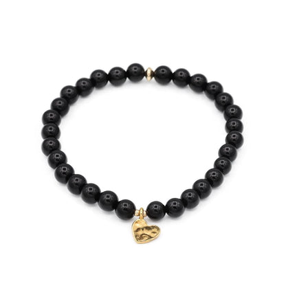 Black Tourmaline Heart from Earthly Abundance showing a polished black crystal in the shape of a heart.