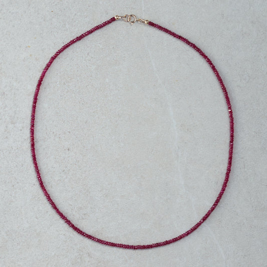 Carmine Longido Ruby Necklace by Earthly Abundance featuring deep red rubies on a delicate gold chain.