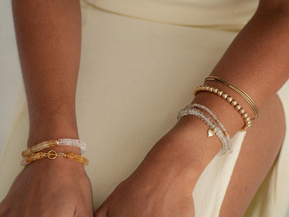 Citrine and clear quartz crystals from Earthly Abundance, showcasing vibrant orange and transparent mineral formations.