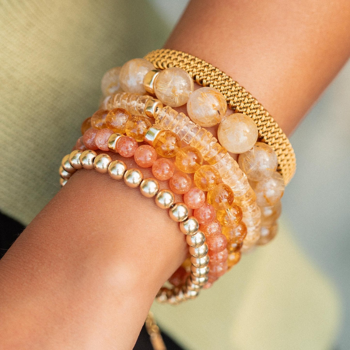 Citrine and clear quartz crystals from Earthly Abundance, showcasing vibrant yellow and transparent gemstones on a neutral background.
