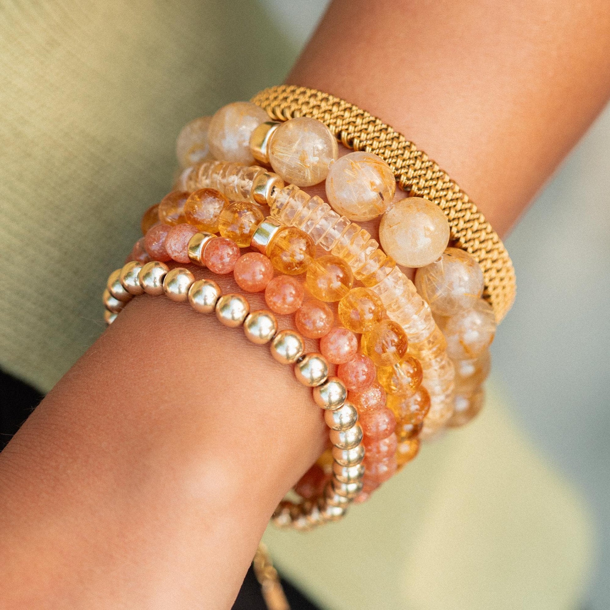 Citrine and clear quartz crystals from Earthly Abundance, showcasing vibrant yellow and transparent gemstones on a neutral background.