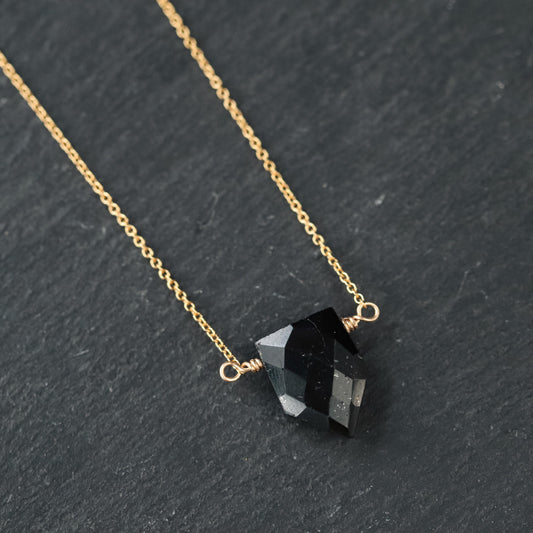 Black tourmaline pendant necklace featuring a polished black stone on a sleek chain, from Earthly Abundance.