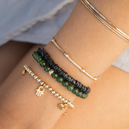 Canadian Jade 6mm gemstone beads from Earthly Abundance, showing smooth, round green jade beads on a neutral background.