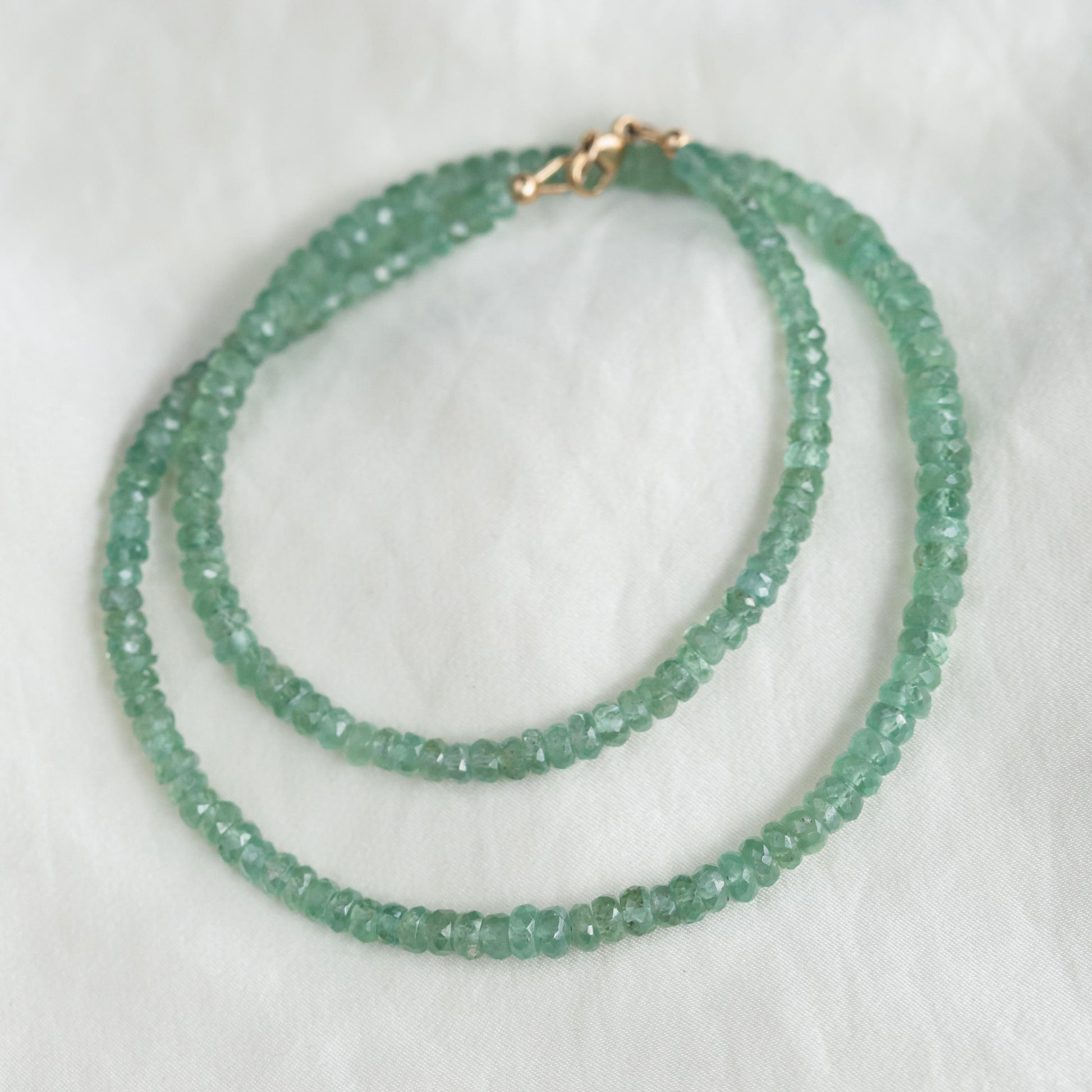 Green Kyanite necklace from Earthly Abundance featuring a polished green kyanite pendant on a leather cord.