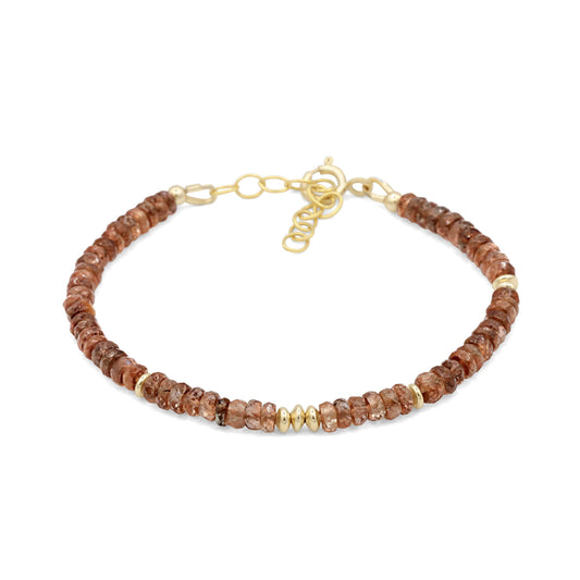 Earthly Abundance Andalusite bracelet featuring polished gemstone beads on a stretch cord, showcasing vibrant green and purple hues.