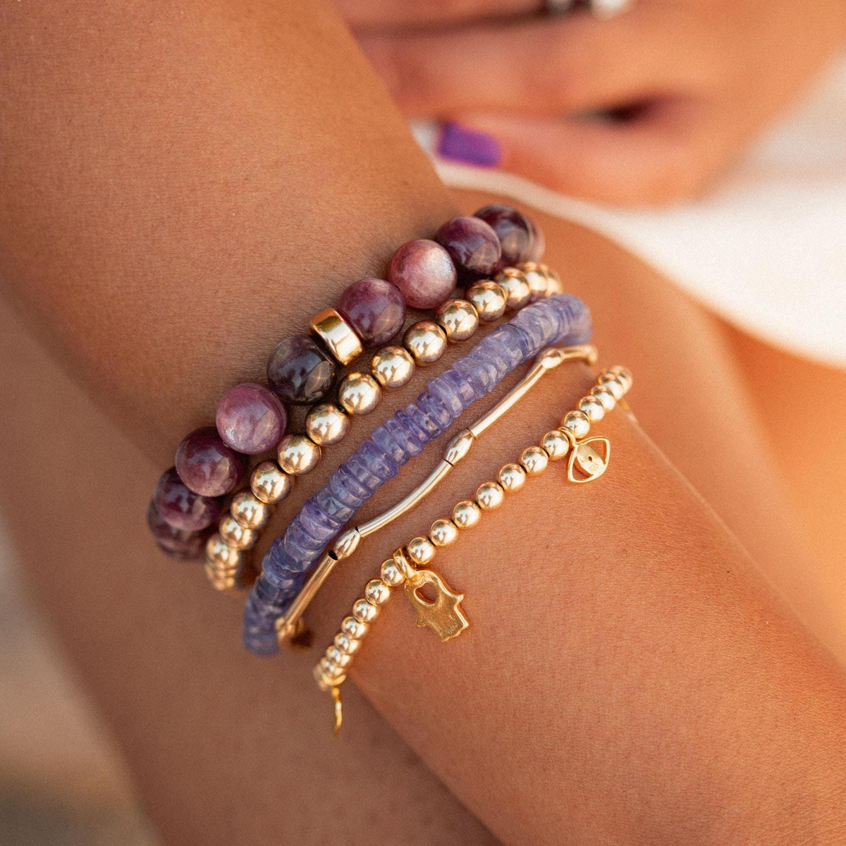 Lepidolite 9mm gemstone bead from Earthly Abundance, showcasing purple and lilac mineral with smooth round surface.