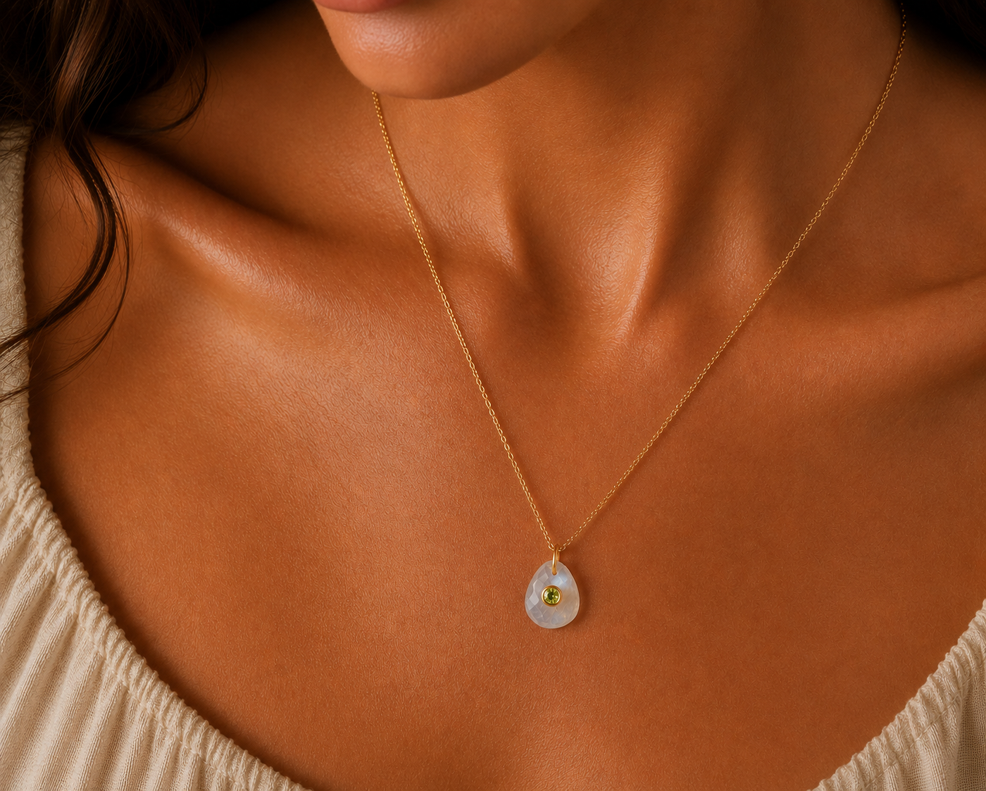 Moonflower pendant featuring moonstone and peridot gemstones, handcrafted by Earthly Abundance, displayed against a neutral background.