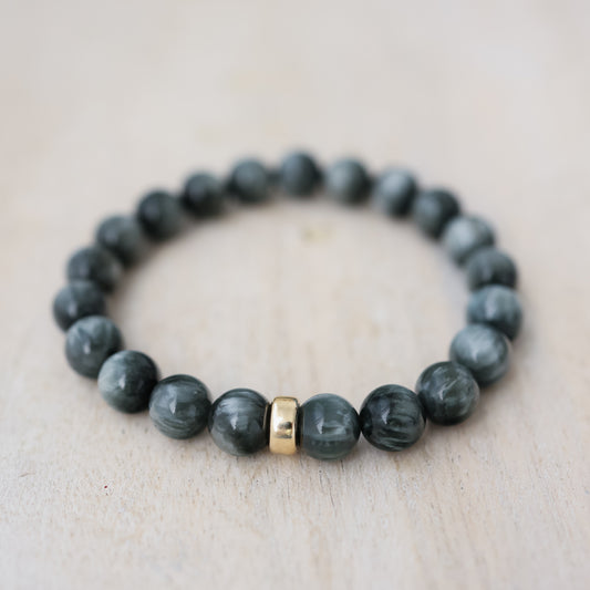 Earthly Abundance Cats Eye Bracelet with 8mm round beads, showcasing a glossy, eye-catching gemstone design.