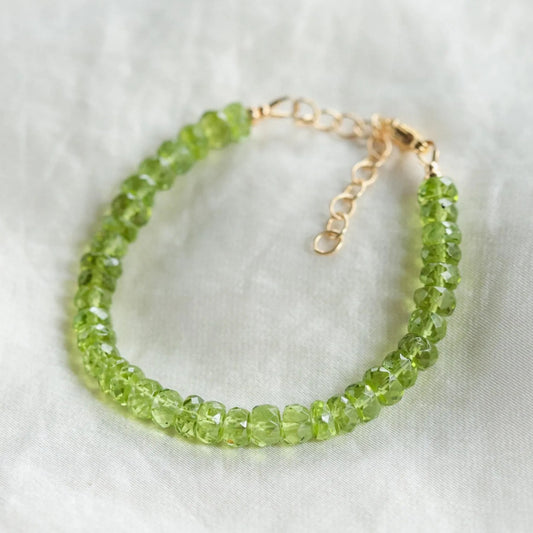 Faceted peridot rondel bracelet by Earthly Abundance featuring vibrant green gemstones on a delicate silver chain.