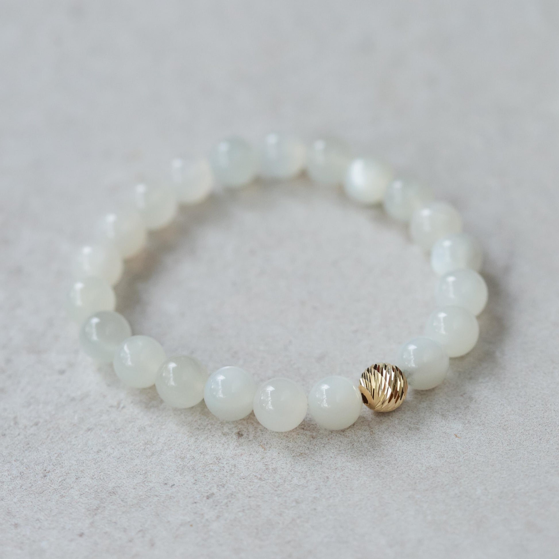 Ethereal Moonstone Bracelet with 14K gold clasp from Earthly Abundance, featuring shimmering moonstone beads on a delicate chain.
