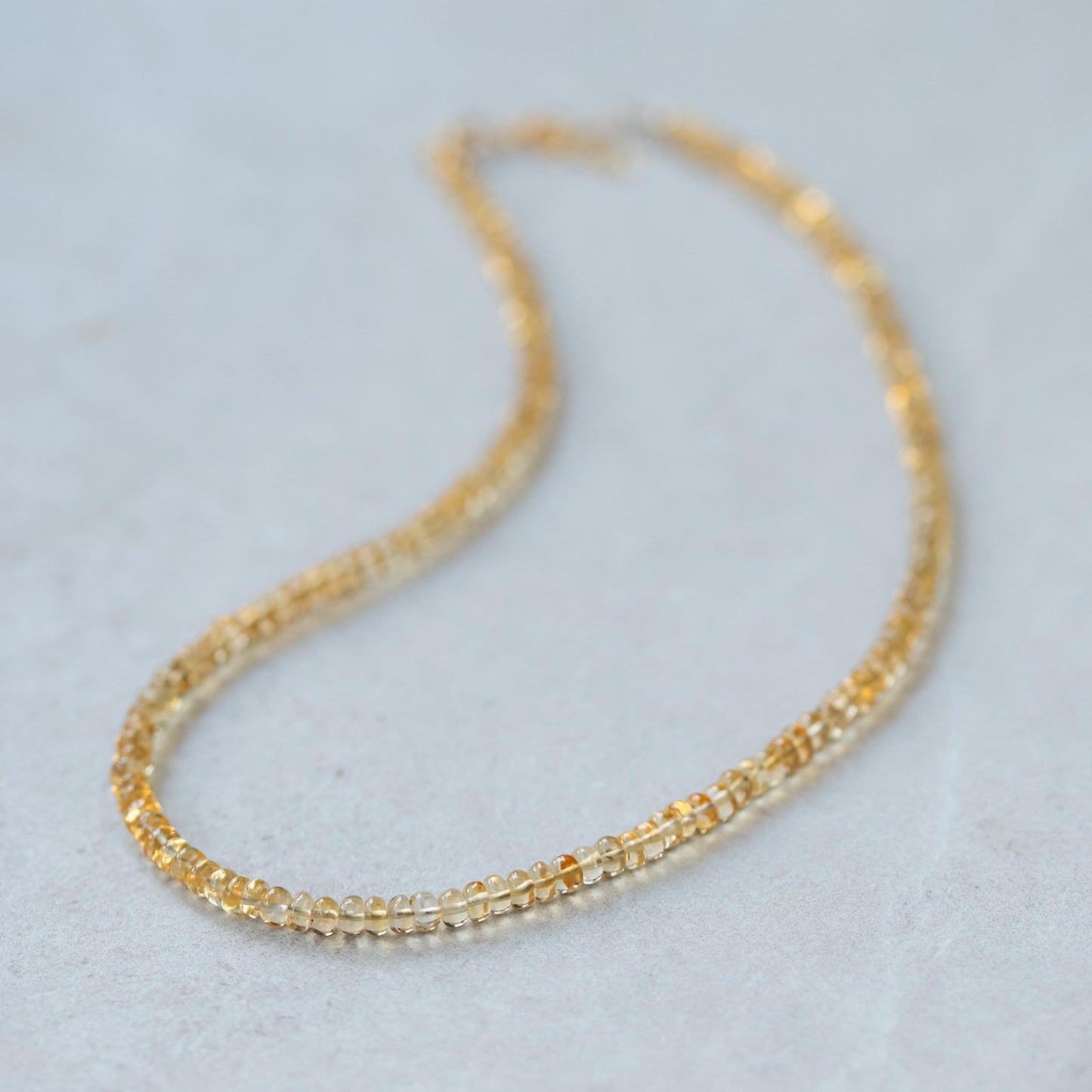 Luminous Citrine Necklace from Earthly Abundance featuring a large, polished citrine gemstone on a delicate chain.