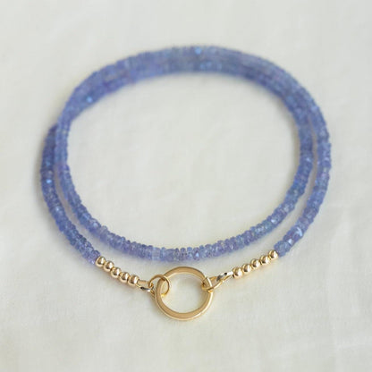 Tanzanite Aura Necklace with vibrant blue and purple hues, featuring a sparkling gemstone pendant on a delicate chain from Earthly Abundance Jewelry.