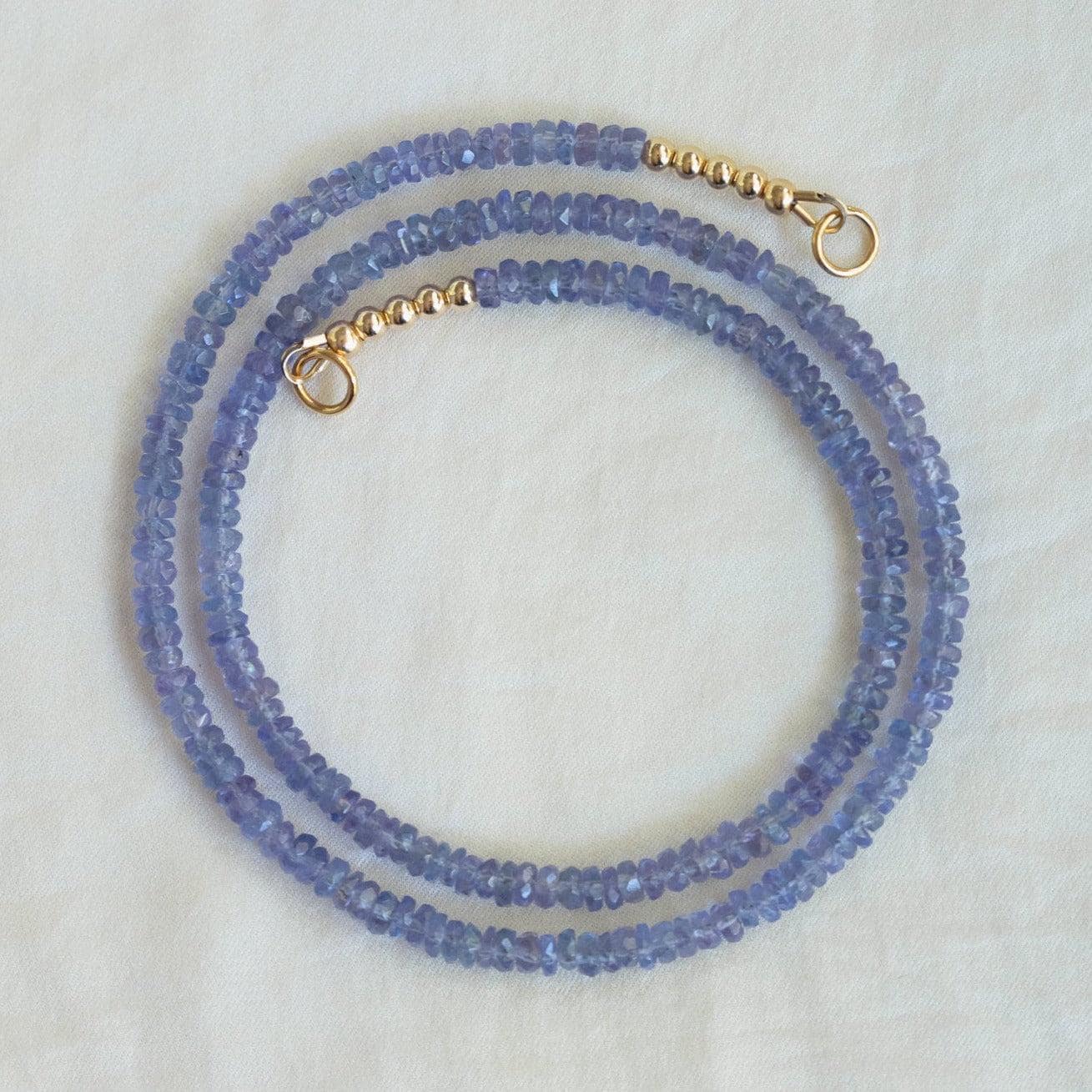 Tanzanite Aura Necklace by Earthly Abundance Jewelry featuring a vibrant blue-purple gemstone pendant with silver chain.