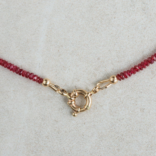 14K Anchor Ruby Necklace by Earthly Abundance featuring a sterling silver anchor pendant with a vibrant red ruby gemstone.