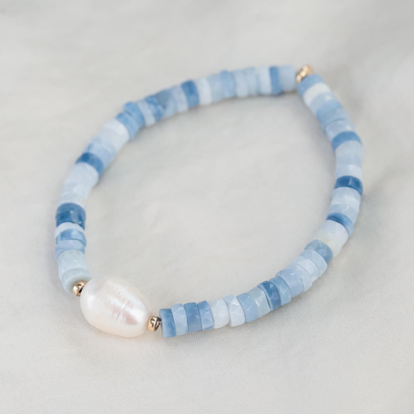 Heishi gemstone and pearl bracelet featuring colorful beads and white pearls, handcrafted by Earthly Abundance.