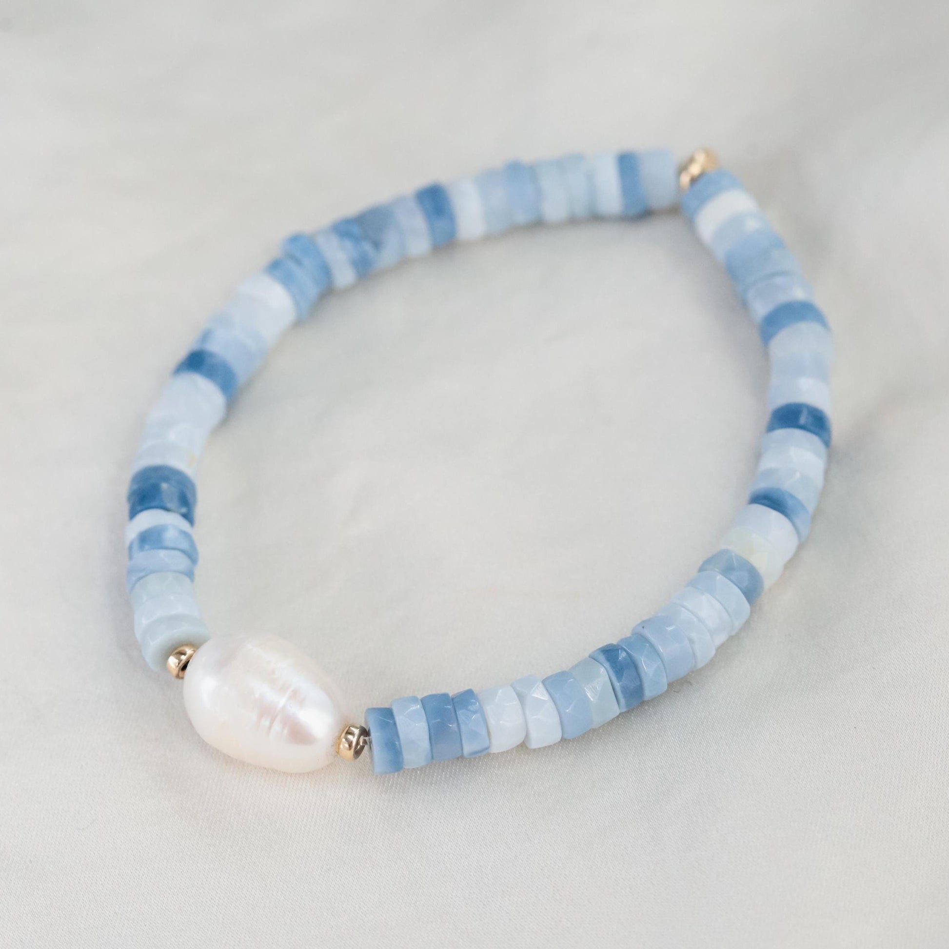 Heishi gemstone and pearl bracelet featuring colorful beads and white pearls, handcrafted by Earthly Abundance.