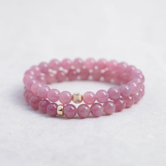 Earthly Abundance Madagascar Rose Quartz bracelet featuring polished pink gemstone beads on an elastic band.