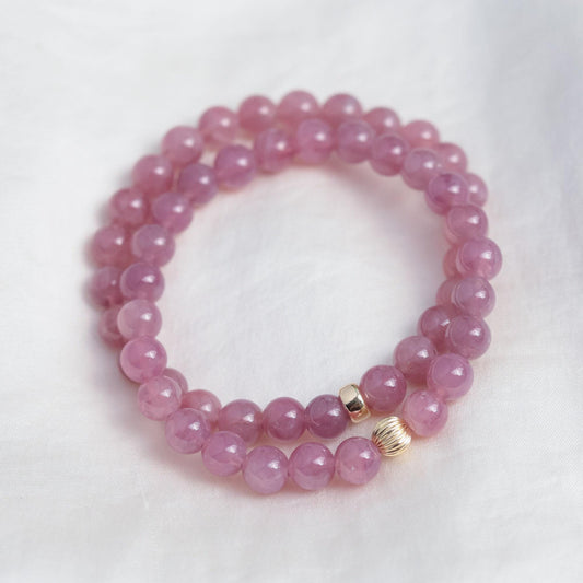 Madagascar Rose Quartz bracelet by Earthly Abundance featuring polished pink quartz beads on an elastic band.
