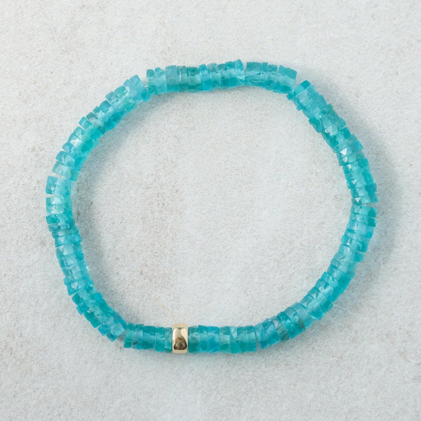 Aapatite Heishi bracelet from Earthly Abundance featuring small, round blue-green apatite stone beads on an elastic band.