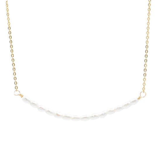 Elegant pearl bar necklace by Earthly Abundance featuring a sleek bar pendant with lustrous pearls on a delicate chain.