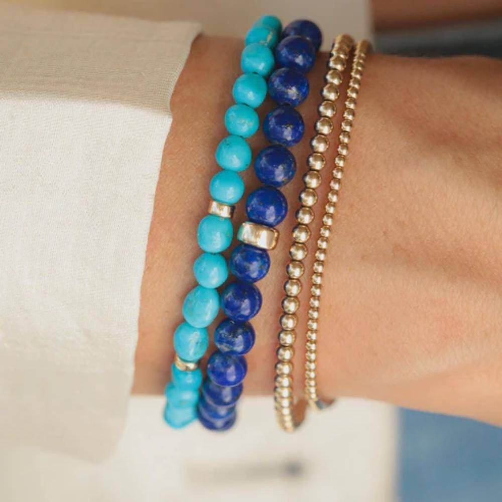 Lapis Lazuli bracelet from Earthly Abundance Jewelry featuring deep blue stones with gold flecks on a delicate string.
