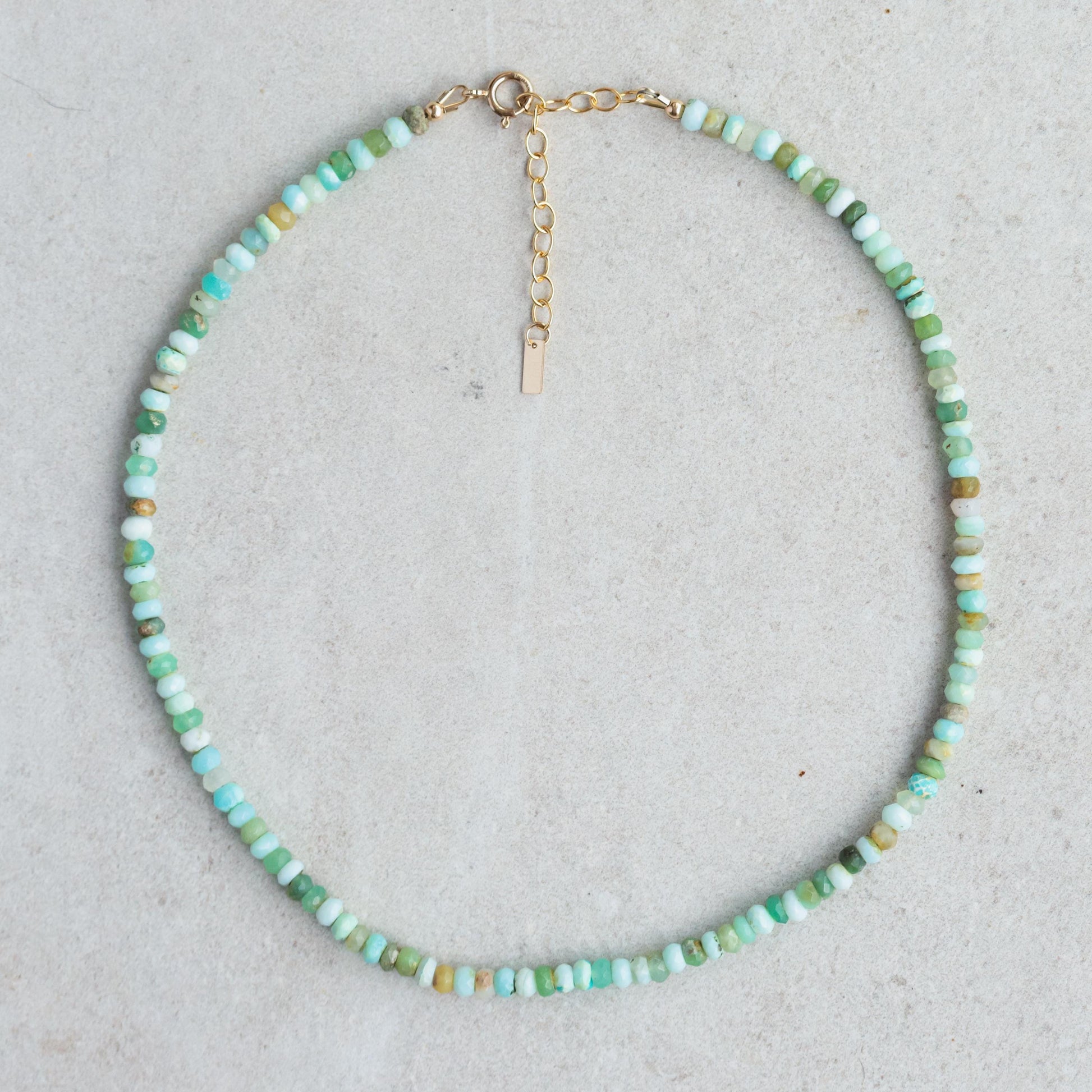 Peruvian opal necklace with polished beads and silver clasp, featuring vibrant, colorful natural stone gemstones from Earthly Abundance.