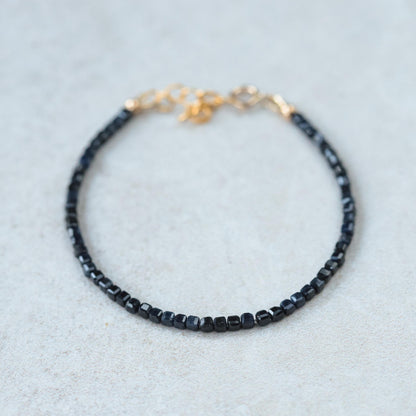 Cube-cut gemstone bracelet featuring 14K gold setting from Earthly Abundance, showcasing vibrant, polished gemstones on a delicate chain.