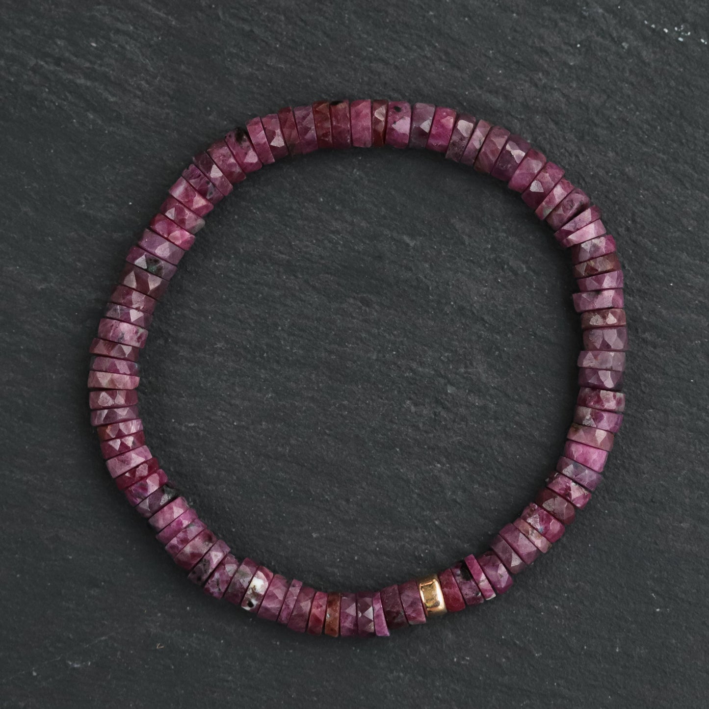 Earthly Abundance Ruby Heishi bracelet featuring small red ruby beads strung together on a delicate cord.