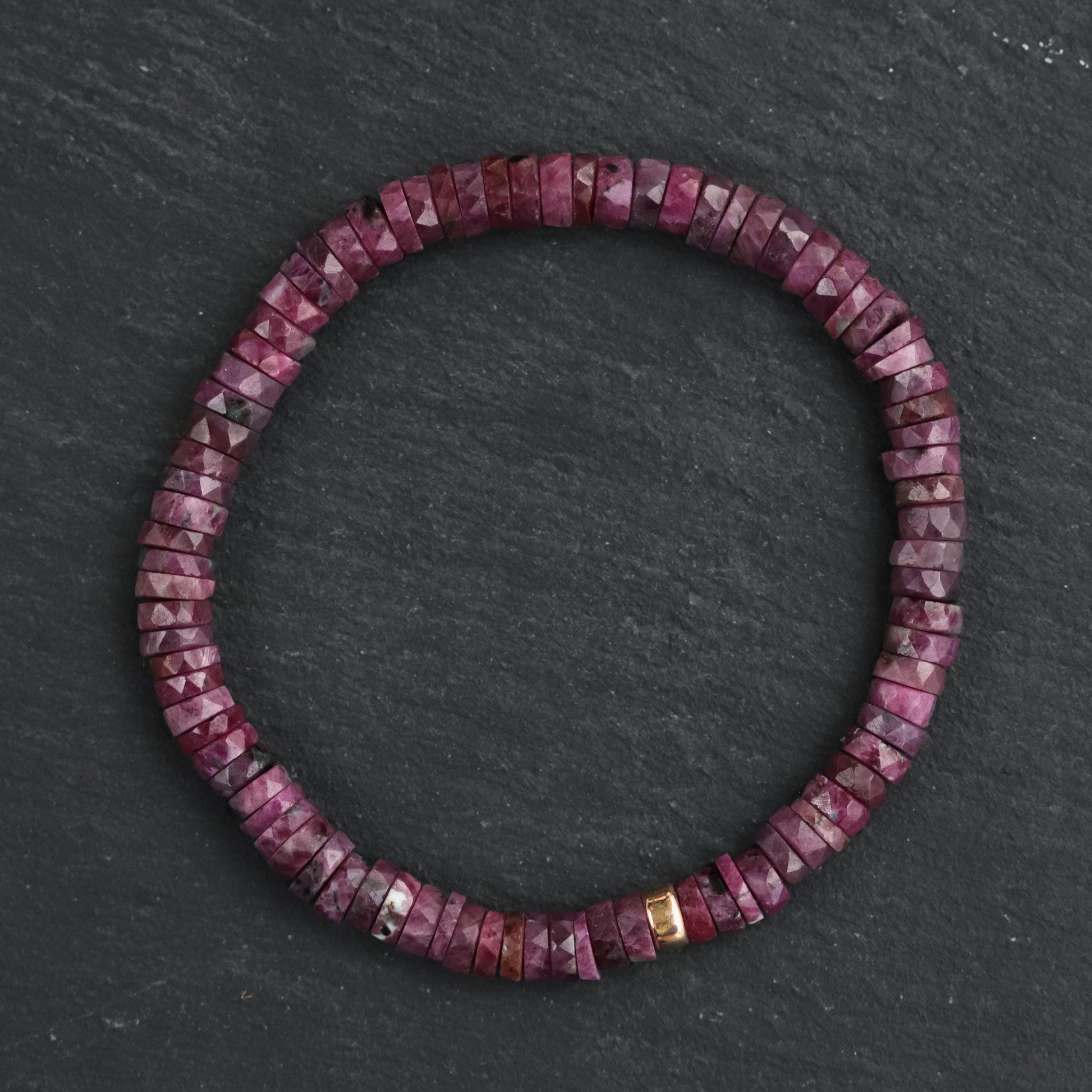 Earthly Abundance Ruby Heishi bracelet featuring small red ruby beads strung together on a delicate cord.