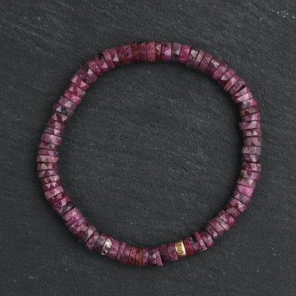 Earthly Abundance Ruby Heishi bracelet featuring small red ruby beads strung together on a delicate cord.