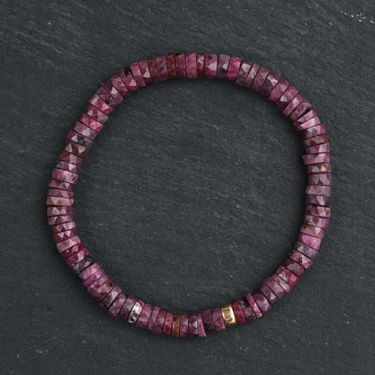 Earthly Abundance Ruby Heishi bracelet featuring small red ruby beads strung together on a delicate cord.