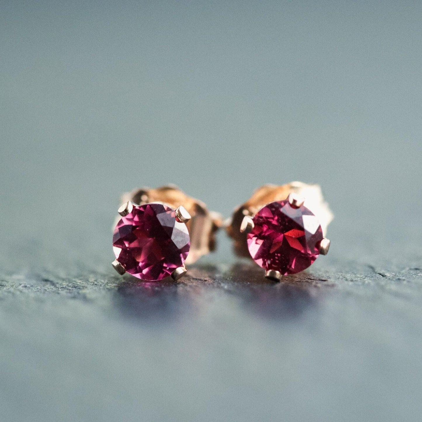 Pink Tourmaline stud earring by Earthly Abundance featuring a vibrant pink gemstone set in a silver post.