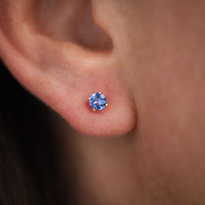 Earthly Abundance tanzanite stud earrings featuring vibrant blue-purple gemstones set in sterling silver.