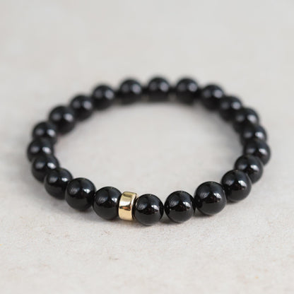 Black Tourmaline bracelet from Earthly Abundance Jewelry featuring protective, polished black stones on a stretch band.
