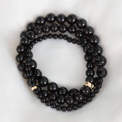 Black tourmaline bracelet by Earthly Abundance Jewelry featuring protective black stones on a stretch cord.
