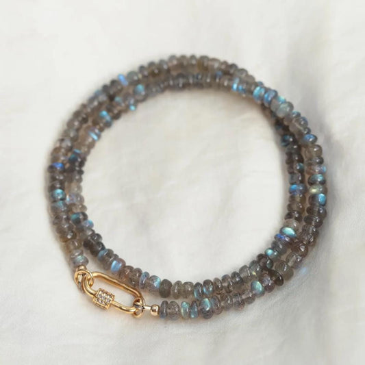 Labradorite and white topaz carabiner necklace with silver chain, featuring a polished labradorite gemstone and sparkling topaz accents.