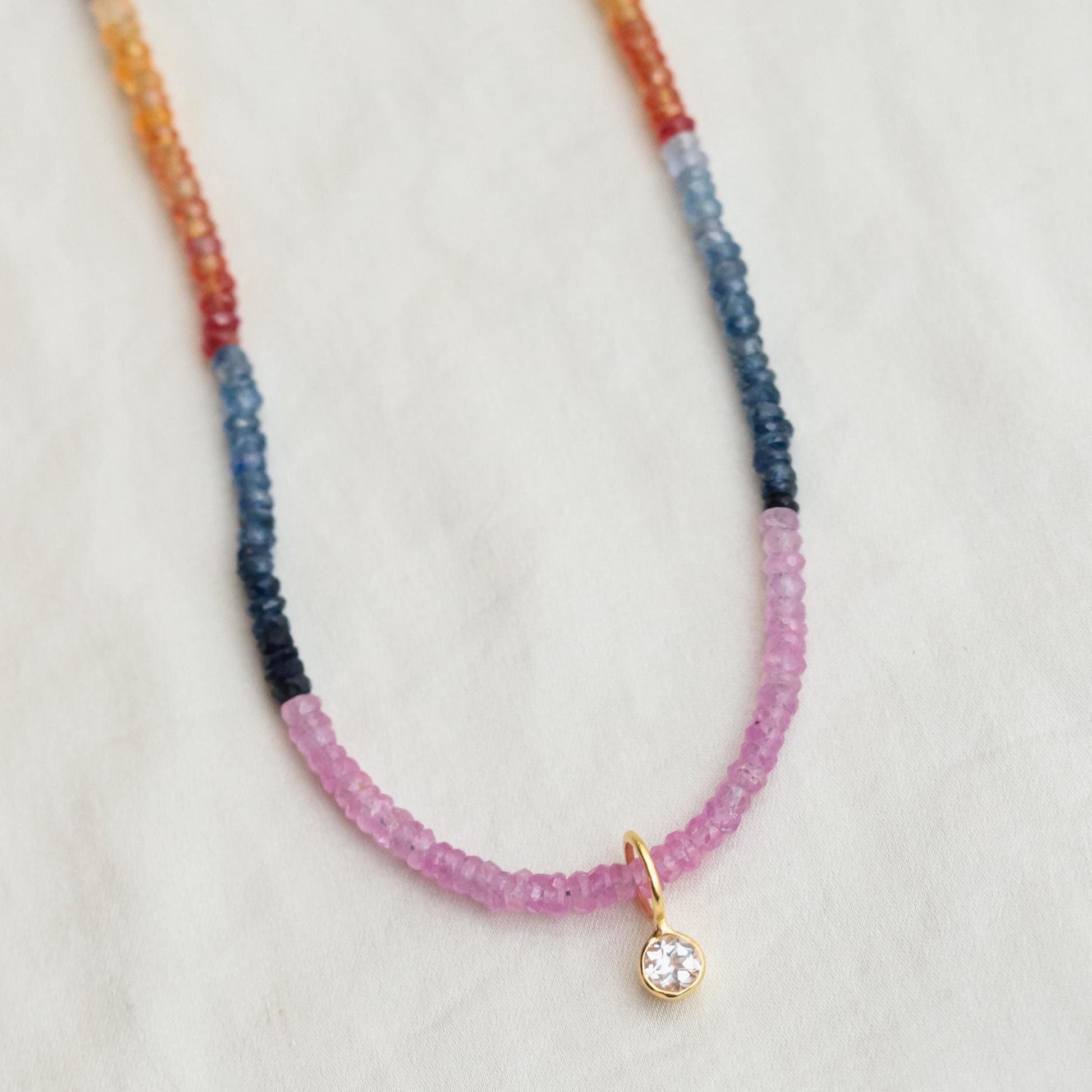 Multi sapphire necklace by Earthly Abundance featuring vibrant blue and pink sapphires on a delicate silver chain.