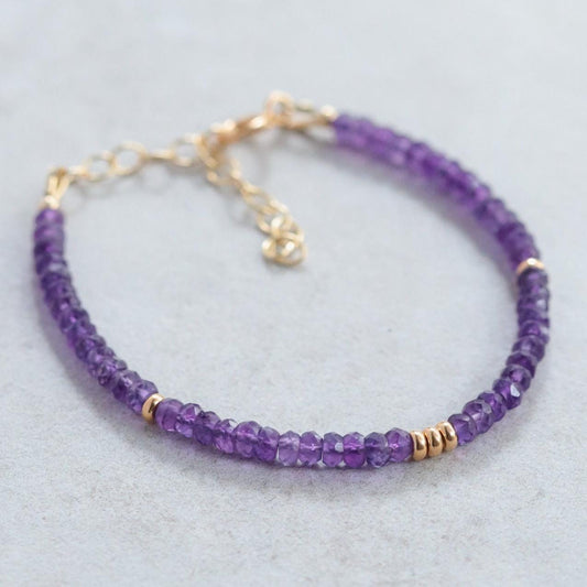 African Amethyst bracelet featuring polished purple beads on a stretchy cord, designed by Earthly Abundance Jewelry.