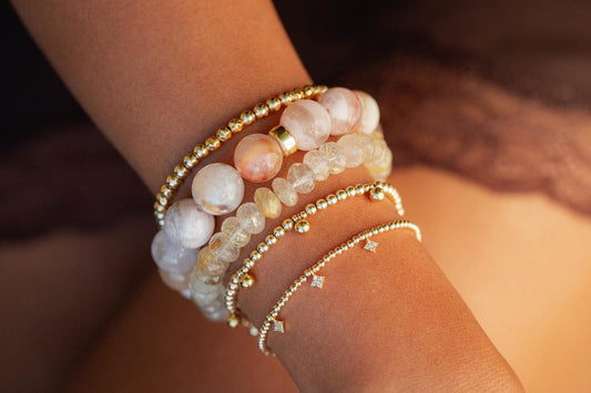 Golden rutilated quartz bracelet featuring polished beads with golden needle-like inclusions, crafted by Earthly Abundance.