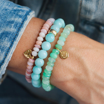 Chrysoprase Smiley Bracelet by Earthly Abundance featuring green gemstone beads and a smiling charm on a delicate bracelet.
